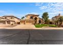 Charming two-story home featuring a three-car garage, landscaped front yard, and a well-maintained lawn at 4223 N St Elias --, Mesa, AZ 85215