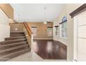 Spacious living room with hardwood floors, large windows offering natural light, and a staircase at 4223 N St Elias --, Mesa, AZ 85215