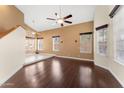 Bright living area featuring hardwood floors, high ceilings, and stylish light fixtures at 4223 N St Elias --, Mesa, AZ 85215