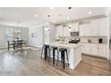 Open-concept kitchen with quartz countertops, island, and stainless steel appliances at 4360 N 186Th Ln, Goodyear, AZ 85395