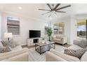 Comfortable living room with modern decor, ceiling fan, and natural light at 4360 N 186Th Ln, Goodyear, AZ 85395