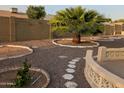 Desert landscaping and palm trees enhance the fenced backyard at 6722 E El Paso St, Mesa, AZ 85205