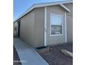 Exterior of home featuring tan siding, white trim, and well-maintained landscaping at 6839 W Taylor St # 209, Phoenix, AZ 85043
