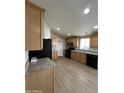 Kitchen featuring wood cabinets, modern appliances, and neutral countertops at 6839 W Taylor St # 209, Phoenix, AZ 85043