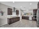Modern kitchen featuring stainless steel appliances, dark cabinetry, granite countertops, and tile backsplash at 7070 W Andrea Dr, Peoria, AZ 85383