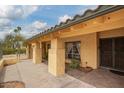 Inviting covered patio space with tiled flooring and gated entry, perfect for enjoying the outdoors in privacy at 7252 E Edgewood Ave, Mesa, AZ 85208