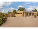 Spacious home featuring a large driveway, a two-car garage, and secure gated access for enhanced privacy at 7252 E Edgewood Ave, Mesa, AZ 85208