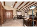 Open living area featuring vaulted ceilings, wooden beams, and a seamless transition to the dining space at 7252 E Edgewood Ave, Mesa, AZ 85208