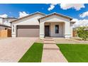 Attractive single-story home with manicured front yard, brick pathway, and covered entryway at 7342 W Hedge Hog Pl, Peoria, AZ 85383