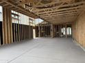 Spacious interior under construction features exposed wood framing, concrete floors, and ample natural light at 7674 W Rowel Rd, Peoria, AZ 85383
