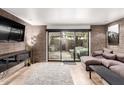 Spacious living room with brick walls, a large sliding door to the outside, and a comfortable sectional sofa at 7740 E Heatherbrae Ave # 13, Scottsdale, AZ 85251