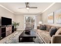 Living room with ceiling fan, tv, and comfortable seating area at 8250 E Arabian Trl # 120, Scottsdale, AZ 85258
