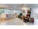 Inviting living room with a plush sofa, armchairs, and wood-look floors at 111 S Greenfield Rd # 670, Mesa, AZ 85206