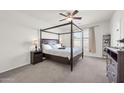 Spacious bedroom with a four-poster bed, complemented by neutral walls and carpet for a serene retreat at 1316 E Spencer St, Casa Grande, AZ 85122