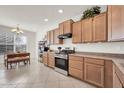 A charming kitchen with light wood cabinetry and a stainless steel oven, complemented by tile flooring and ample natural light at 1316 E Spencer St, Casa Grande, AZ 85122