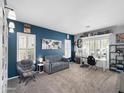 Well-lit home office with a comfortable seating area and built-in desk at 13637 W Port Royale Ln, Surprise, AZ 85379