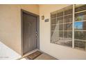 Inviting front door with a welcome mat, unit number, and manicured bushes at 14145 N 92Nd St # 1158, Scottsdale, AZ 85260