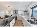 Modern kitchen features stainless steel appliances, ample white cabinetry, and a large center island at 1609 W State Ave, Phoenix, AZ 85021