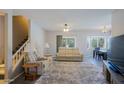 Spacious living room with plush carpet, comfortable seating, and staircase to the second story at 16256 N 64Th Pl, Scottsdale, AZ 85254