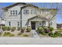Charming two-story home with a landscaped yard and a covered front entrance with stone accents at 16562 W Sierra St, Surprise, AZ 85388
