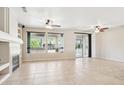 Bright living room with fireplace, ceiling fans, and large windows offering great natural light and outdoor views at 18013 N Sterling Dr, Surprise, AZ 85374