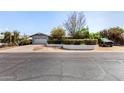 Traditional single-story home with mature landscaping, a manicured lawn, and a driveway at 1837 E Presidio Rd, Phoenix, AZ 85022