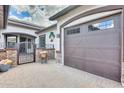 Attached two-car garage with updated door on a home featuring attractive brick accents and paver driveway at 20017 S 192Nd Pl, Queen Creek, AZ 85142