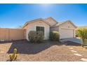 Single-story home with desert landscaping, block wall and a two-car garage at 2031 S 86Th Ln, Tolleson, AZ 85353