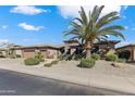 Charming single-story home featuring manicured landscaping and a convenient three-car garage at 20609 N Canyon Whisper Dr, Surprise, AZ 85387