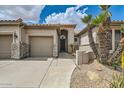 Inviting home with meticulous desert landscaping, palm trees, a three-car garage, and a gated front entryway at 2448 S Salida Del Sol --, Chandler, AZ 85286