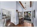 Charming foyer with hardwood floors, decorative light fixture and a view of the kitchen at 2673 Leisure World --, Mesa, AZ 85206