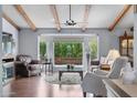 Bright living room featuring exposed beams, large windows, and comfortable seating at 2673 Leisure World --, Mesa, AZ 85206