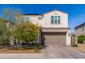 A well-maintained two-story home features a neutral color scheme, a two-car garage, and manicured landscaping at 31020 N 5Th St, Phoenix, AZ 85085