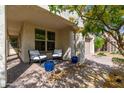 Covered front porch with seating area. Tasteful exterior of the house with potted plants adding charm and curb appeal at 31020 N 5Th St, Phoenix, AZ 85085