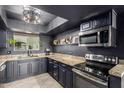 Modern kitchen with granite countertops, stainless steel appliances, and dark cabinetry, offering both style and functionality at 3516 W Brown St, Phoenix, AZ 85051