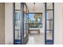 Grand entryway with tile floors, modern light fixture and picturesque desert views at 38199 N Tranquil Way, Carefree, AZ 85377