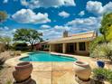 Backyard pool with lush landscaping and a spacious patio area at 4867 E Windstone Trl, Cave Creek, AZ 85331