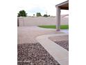 Spacious backyard with an extended patio and a mixture of brick and gravel landscaping at 488 W Harvard Ave, Gilbert, AZ 85233