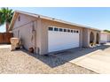 Exterior of the home showing a large, two-car garage and side yard with easy access at 5221 W Garden Dr, Glendale, AZ 85304