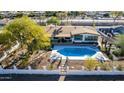 Aerial view of a backyard with a refreshing pool, lounge chairs, and a charming pergola at 544 W Thunderbird Rd, Phoenix, AZ 85023