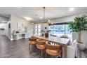 Bright dining room featuring a modern light fixture, stylish decor, and large windows, creating an inviting atmosphere at 5975 E Larkspur Dr, Scottsdale, AZ 85254