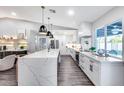 Bright kitchen features a central island, stainless steel appliances, and large windows at 5975 E Larkspur Dr, Scottsdale, AZ 85254