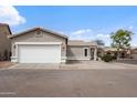 Attached two-car garage and paved driveway offer convenient parking at this single-story home at 6228 S Nash Way, Chandler, AZ 85249