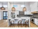 Bright kitchen featuring marble island, stainless steel appliances, stylish pendant lighting, and ample counter space at 6301 N 16Th Dr, Phoenix, AZ 85015