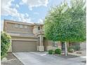 Two-story home with a neutral color scheme, well-maintained landscaping, and an attached two-car garage at 6749 W Charter Oak Rd, Peoria, AZ 85381
