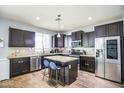 Kitchen featuring granite countertops, stainless steel appliances, and an island with seating at 6749 W Charter Oak Rd, Peoria, AZ 85381
