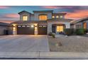 Charming home exterior showcasing a spacious three-car garage and well-maintained landscaping at 7354 E Norwood St, Mesa, AZ 85207