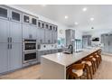 Modern kitchen with sleek gray cabinets, a large island, and stainless steel appliances at 7820 N 5Th Ave, Phoenix, AZ 85021