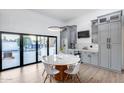 Eat-in kitchen featuring a dining table, stylish cabinets, and seamless indoor-outdoor flow at 7820 N 5Th Ave, Phoenix, AZ 85021