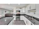 Bright kitchen features stainless steel appliances, a center island, and sleek countertops at 8204 E Turney Ave, Scottsdale, AZ 85251
